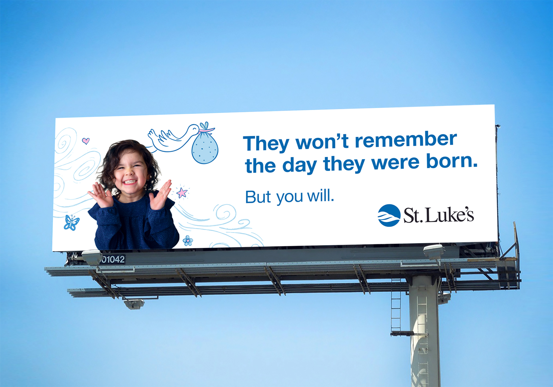 Billboard featuring a young girl excited, it says They won't remember the day they were born, but you will